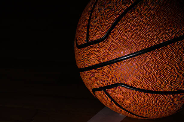 istock Basketball on court black background 545634952