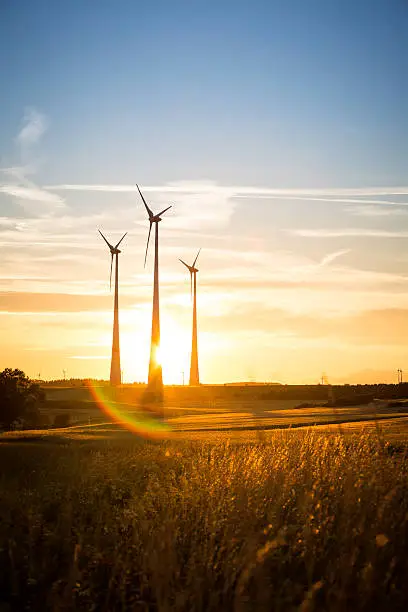 Photo of power generating wind turbines in the countryside in the evening