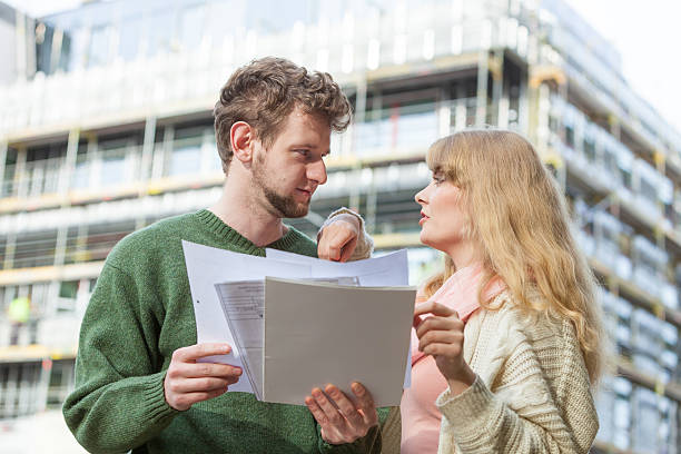 istock Couple with blueprint project keys on construction site 545637778
