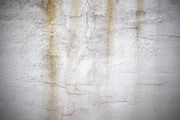 istock Cracked concrete old and dirty wall background 545639304