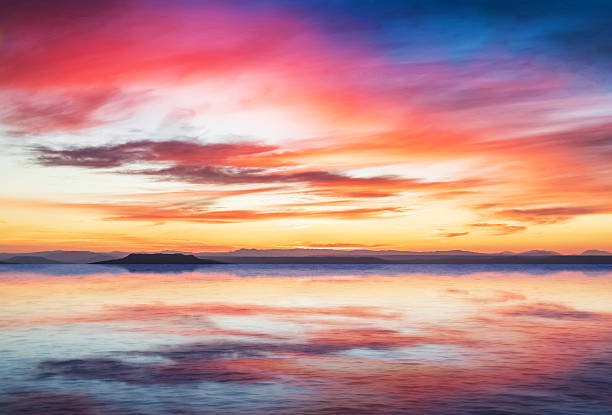 istock sunset scene on quiet sea with mountains in background 545640670