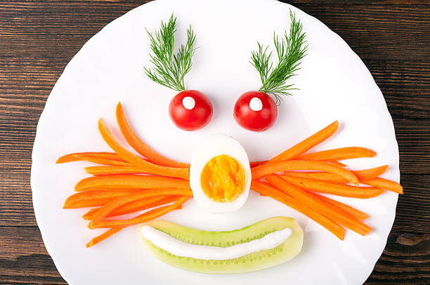 istock Funny breakfast for kids with vegetables, egg and herbs 545640894