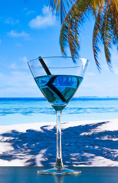 istock blue cocktail on beach on wood table 545643180
