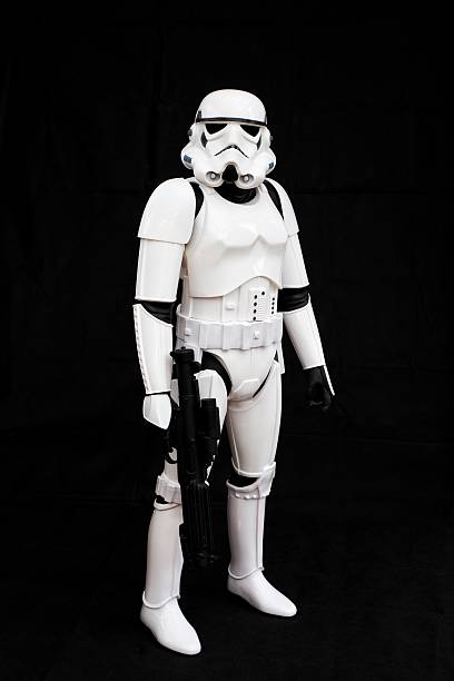 Star Wars Stormtrooper York, UK - July 1, 2016. A full length image of a Star Wars Imperial Stormtrooper from The Force Awakens movie carrying a blaster and isolated against a black background. star wars stock pictures, royalty-free photos & images