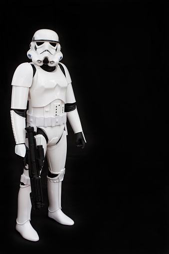 York, U.K. - July 1, 2016. A full length portrait of a Star Wars Imperial Stormtrooper from The Force Awakens movie against a black background.