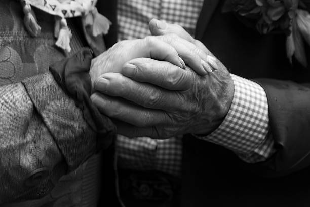 istock Old man and old woman holding hands.Black and white 545644472