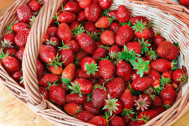 istock Big strawberry in wooden basket. 545644766