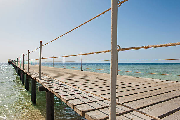 istock Wooden pier from beach on tropical sea 545646564