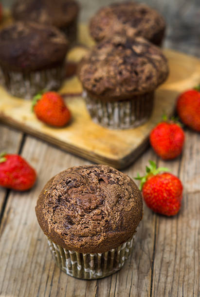 istock Chocolate muffins on the rustic wooden table 545648338