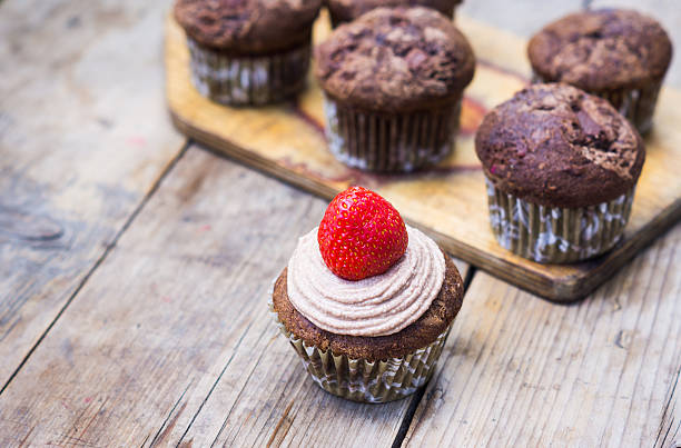 istock Chocolate muffins on the rustic wooden table 545650028