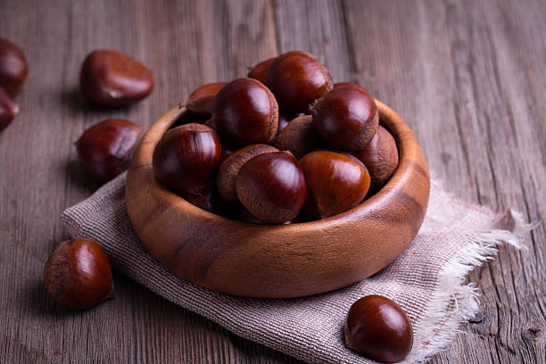 istock chestnuts on the old wooden table 545651218