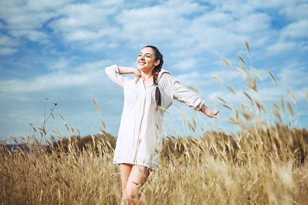 istock Pretty young woman in field at sunset 545651492
