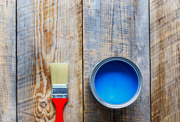 istock painting with can blue paint on wooden background top view 545651664