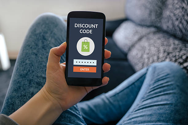 Girl holding smart phone with discount code concept on screen Girl holding smart phone with discount code concept on screen. All screen content is designed by me coupon photos stock pictures, royalty-free photos & images