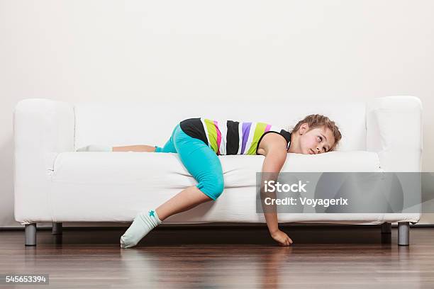 Tired Exhausted Lazy Little Girl Kid Lying On Sofa Stock Photo - Download Image Now - Child, Boredom, Laziness