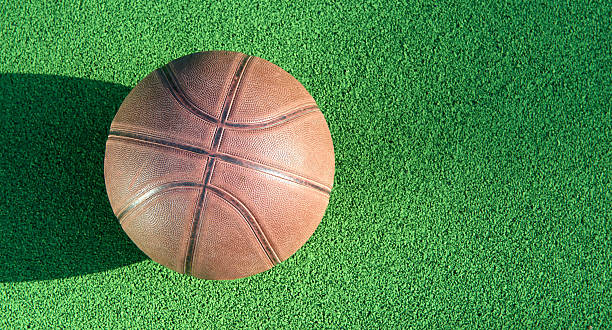 istock Basketball ball on green field floor 545654390