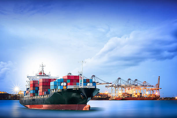 Logistics and transportation of International Container Cargo ship Logistics and transportation of International Container Cargo ship with ports crane bridge in harbor for logistic import export background and transport industry. wine shipping stock pictures, royalty-free photos & images