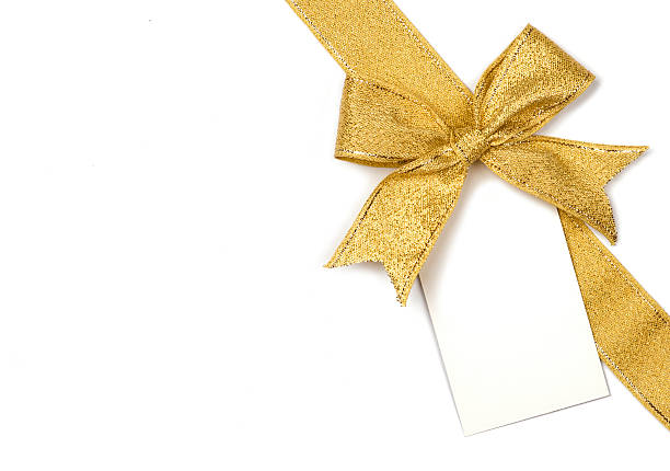 Golden ribbon with bow and card Golden ribbon with bow and card isolated on white gift tag note stock pictures, royalty-free photos & images