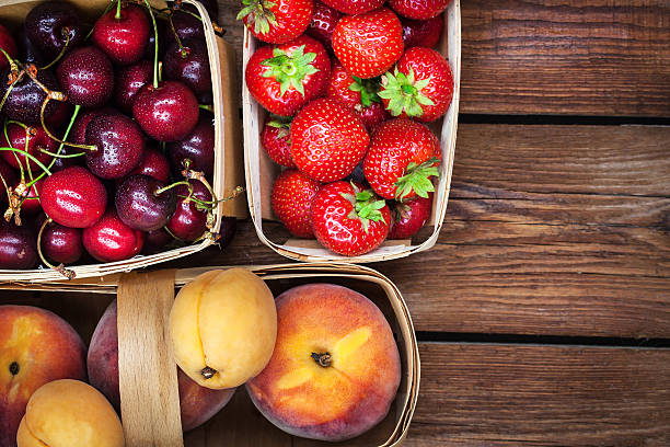 istock Fresh ripe summer berries and fruits in baskets 545656226