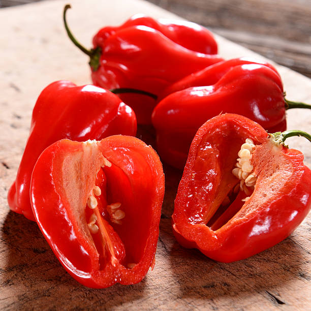 istock Fresh habanero peppers on wooden background 545656438