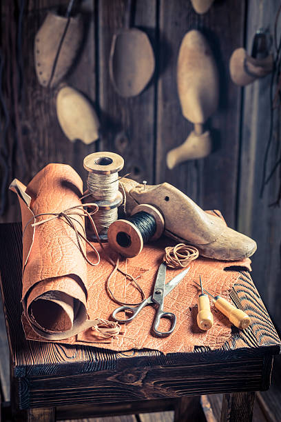 istock Shoemakers workplace with shoes, leathers and tools 545657378