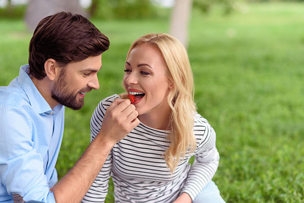 istock Happy man feeding woman with berry 545657872