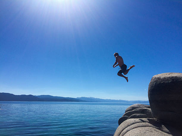 istock Man cliff jumping into Lake Tahoe 545658674