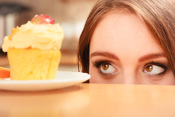 istock Woman looking at delicious sweet cake. Gluttony. 545658768