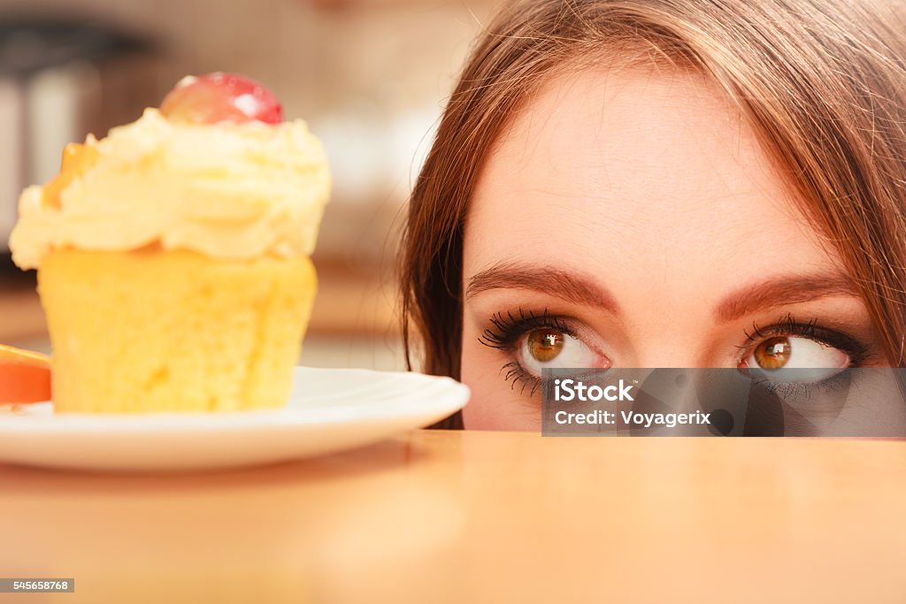 Woman looking at delicious sweet cake. Gluttony. Woman looking at delicious cake with sweet cream and fruits on top. Appetite and gluttony concept. Women Stock Photo