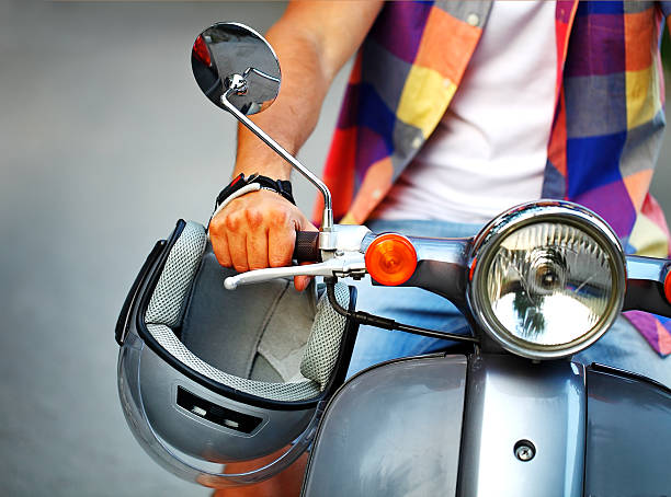 istock Man riding old retro scooter in a city street 545658948