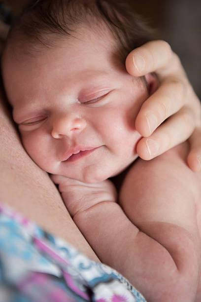 istock mother holding newborn 545658990