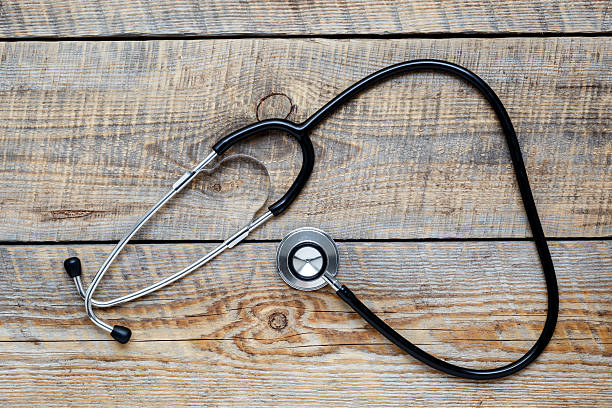 istock new stethoscope on wooden table isolated top view 545659626