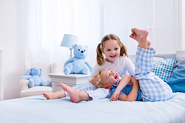 istock Kids playing in white bedroom 545660172