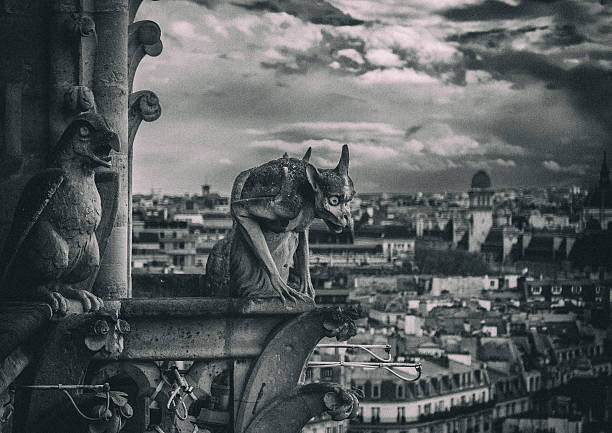 Gargoyle Statue Against cloudy sky and Paris cityscape. Monochrome toned image