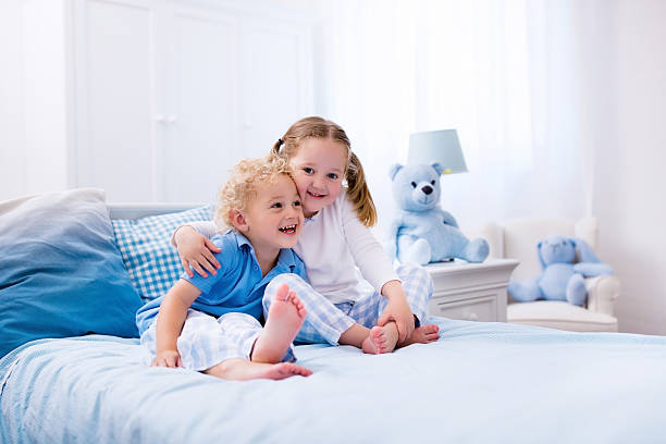 istock Happy kids playing in white bedroom 545660548