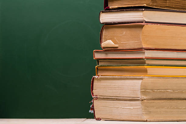 istock Srack of books in front of school board 545660728