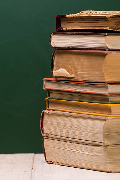 istock Stack of books in front of school board 545660790