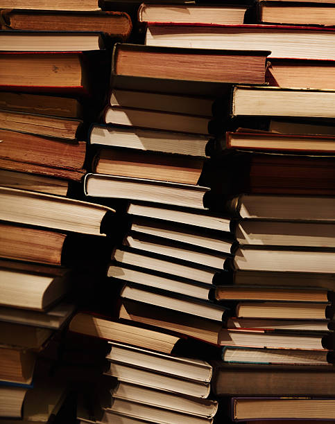 istock Pile of old dirty books on book shelf 545660896