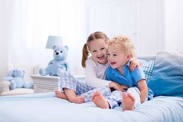 istock Little kids playing in white bedroom 545660906