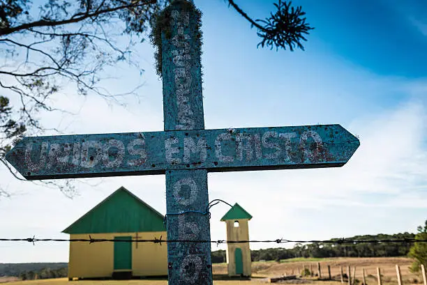 View of a cross and a wooden church on a rural area in Rio Grande do Sul state, Brazil