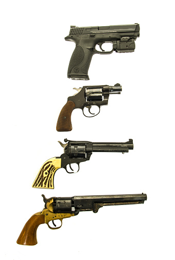  Winneconne, WI, USA  - January 20, 2016: Four different hand guns.  Ranging from the modern day 9mm to a civil war pistol.