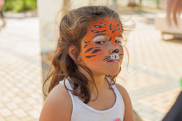 istock Little girl with her face painted like a tiger 545661912