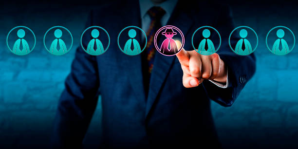 Manager Identifying Potential Insider Threat Corporate security manager identifies a potential insider threat in a line-up of eight white collar workers. Hacker or spy icon lights up purple. Cybersecurity and human resources challenge concept. threats stock pictures, royalty-free photos & images