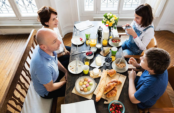 istock Happy Family Having Breakfast together, Overhead View 545662554