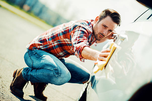 istock Young man cleaning his car outdoors 545662926