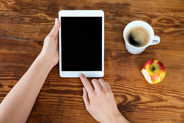 istock Woman Hands With Tablet, Apple and coffee 545664060