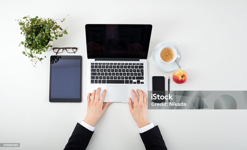 Woman Hands With Tablet, Laptop, Smartphone  and coffee Woman Hands With Tablet, Laptop, Smartphone, apple and coffee Apple - Fruit Stock Photo