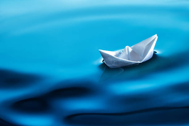 istock small paper boat in water 545665662