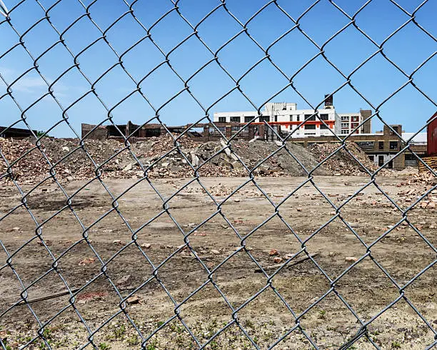 Photo of Old factory building viewed through fence