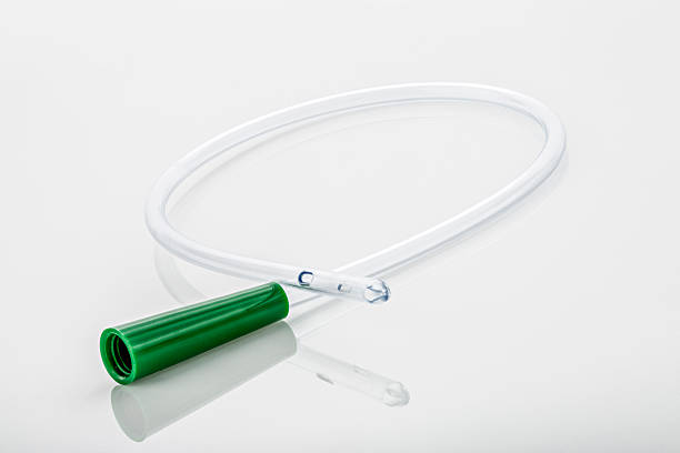 Male Urinary Catheter, Straight Tip A male, straight tipped, non-lubricated, size 14 French, 16 inch urinary catheter with reflection, on a white background. catheter photos stock pictures, royalty-free photos & images